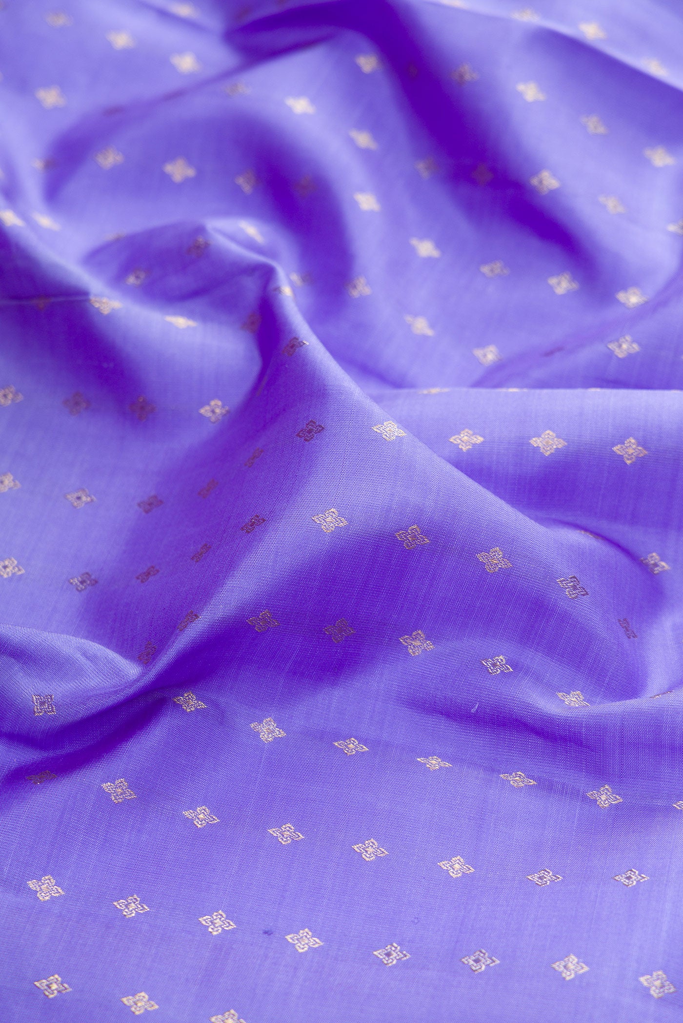 Close up of Lavender Kanchipuram Silk Saree with Zari Butta on the body and Without Border.  displaying folds