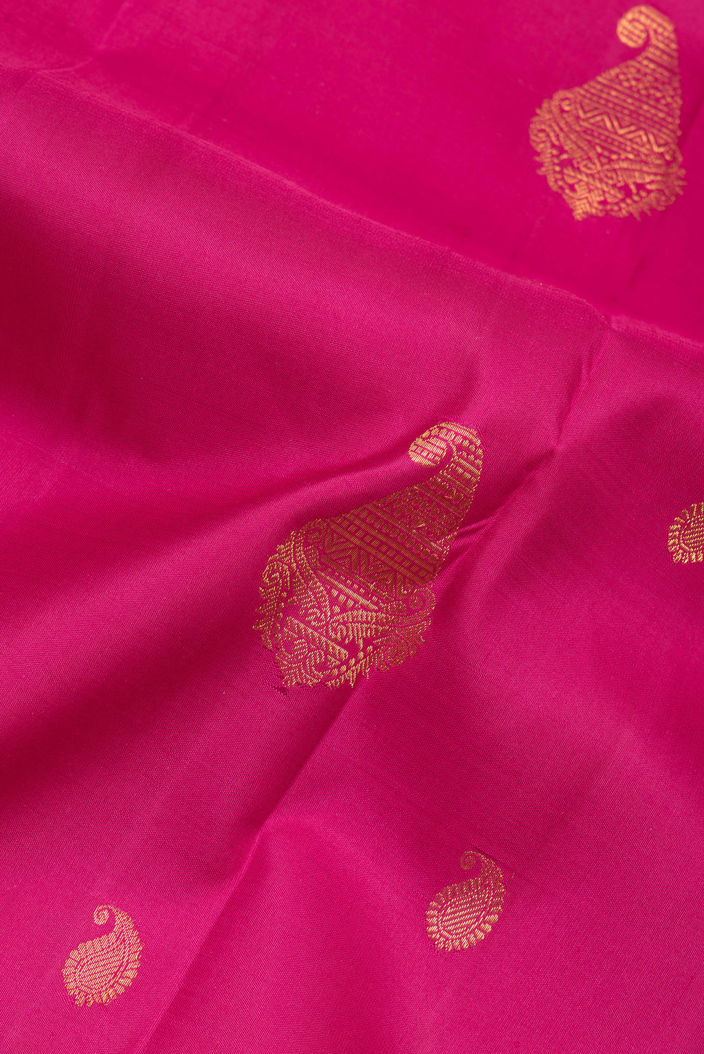 Close up of Pure Silk Pink Kanjivaram Saree with Zari Butta on the body and Zari Border.  displaying folds