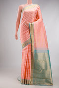 Peach Kanjivaram Silk Saree with Stripes on the body and Zari Border.  displayed on a mannequin