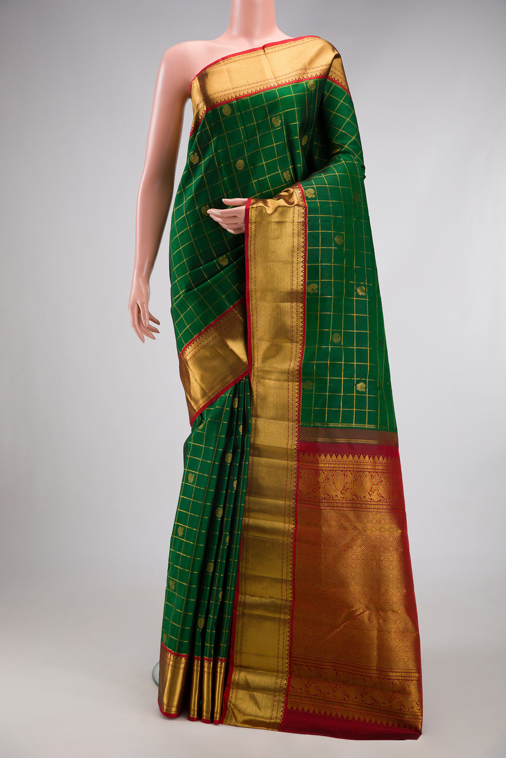 Bottle Green Kanjivaram Silk Saree with Checked design on the body and Zari Border.  displayed on a mannequin