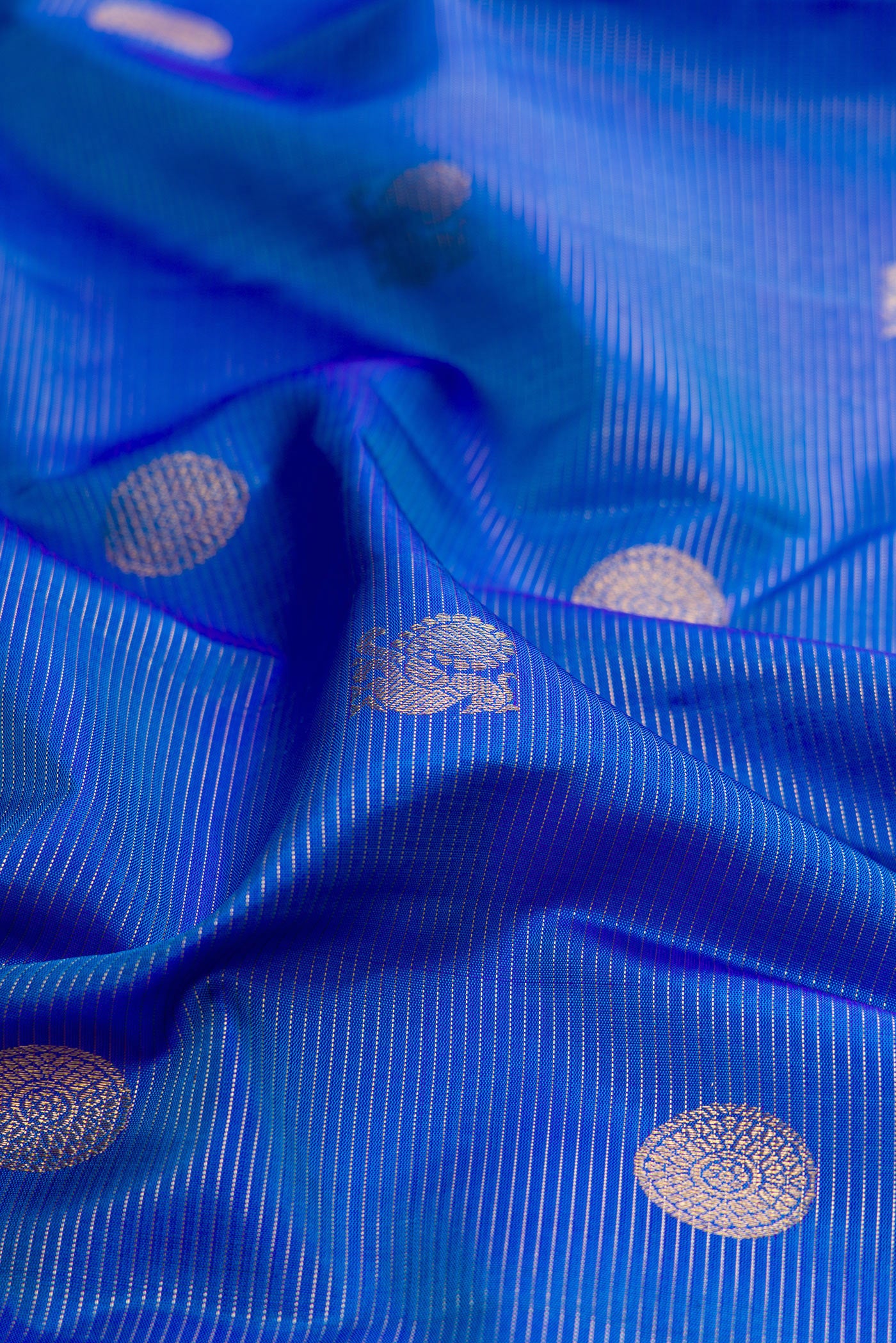 Close up of Royal Blue Kanjivaram Silk Saree with Stripes on the body and Zari Border.  displaying folds