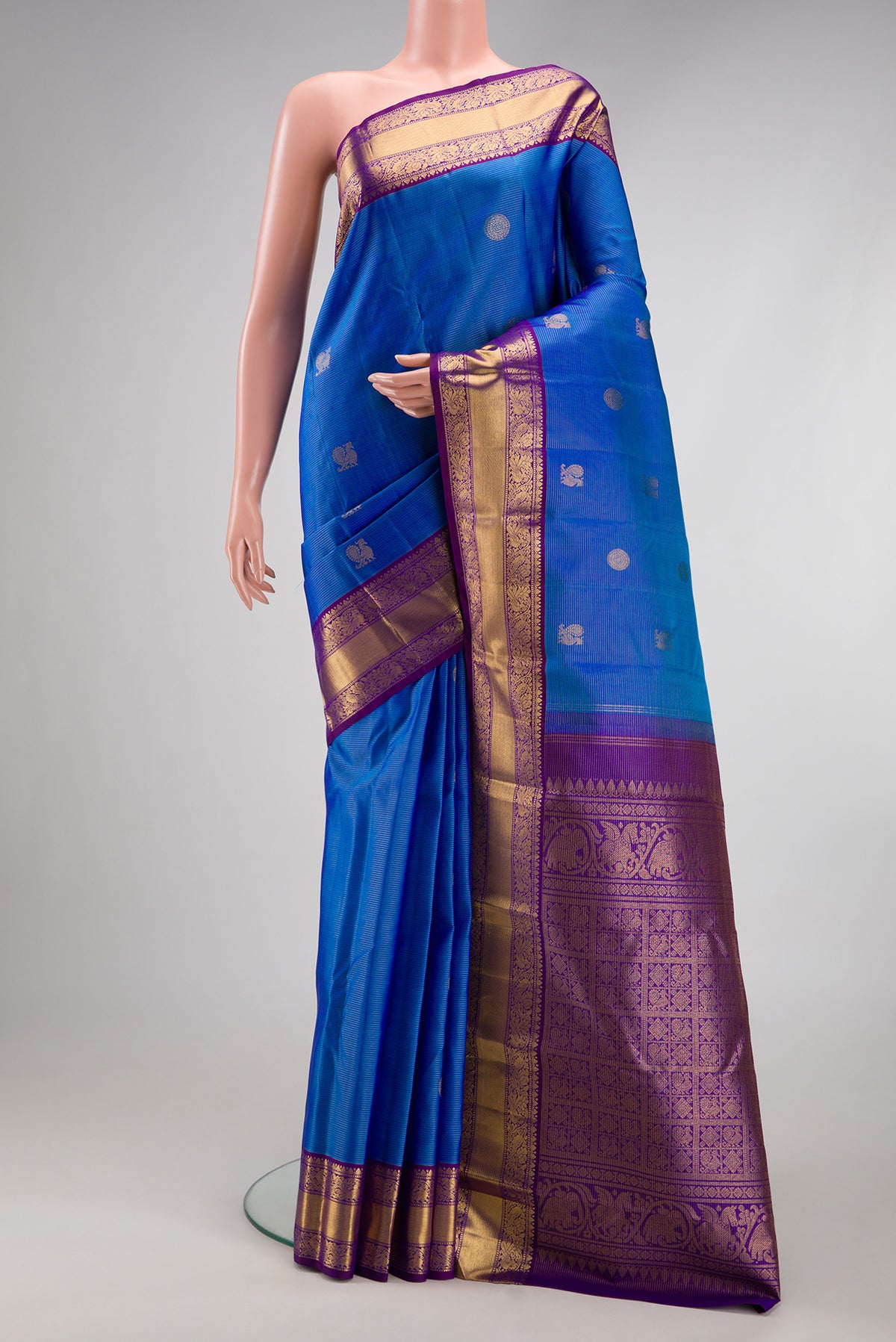 Royal Blue Kanjivaram Silk Saree with Stripes on the body and Zari Border.  displayed on a mannequin