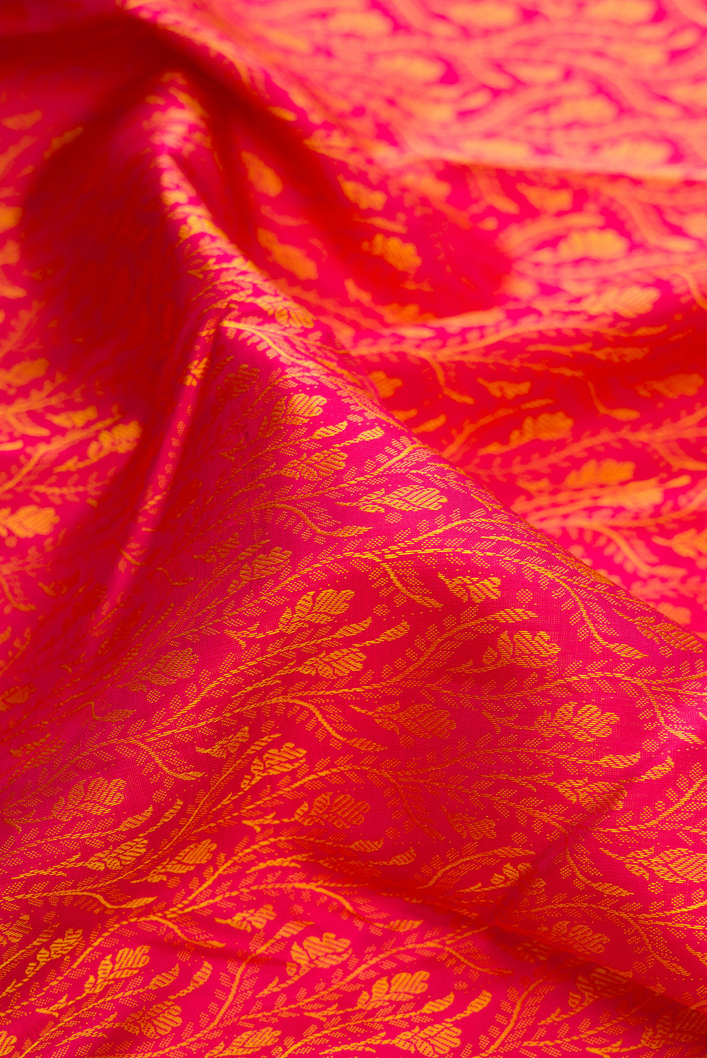 Close up of Pure Silk Pink Dual Tone Kanchipuram Saree with Jacquard design on the body and Zari Border.  displaying folds