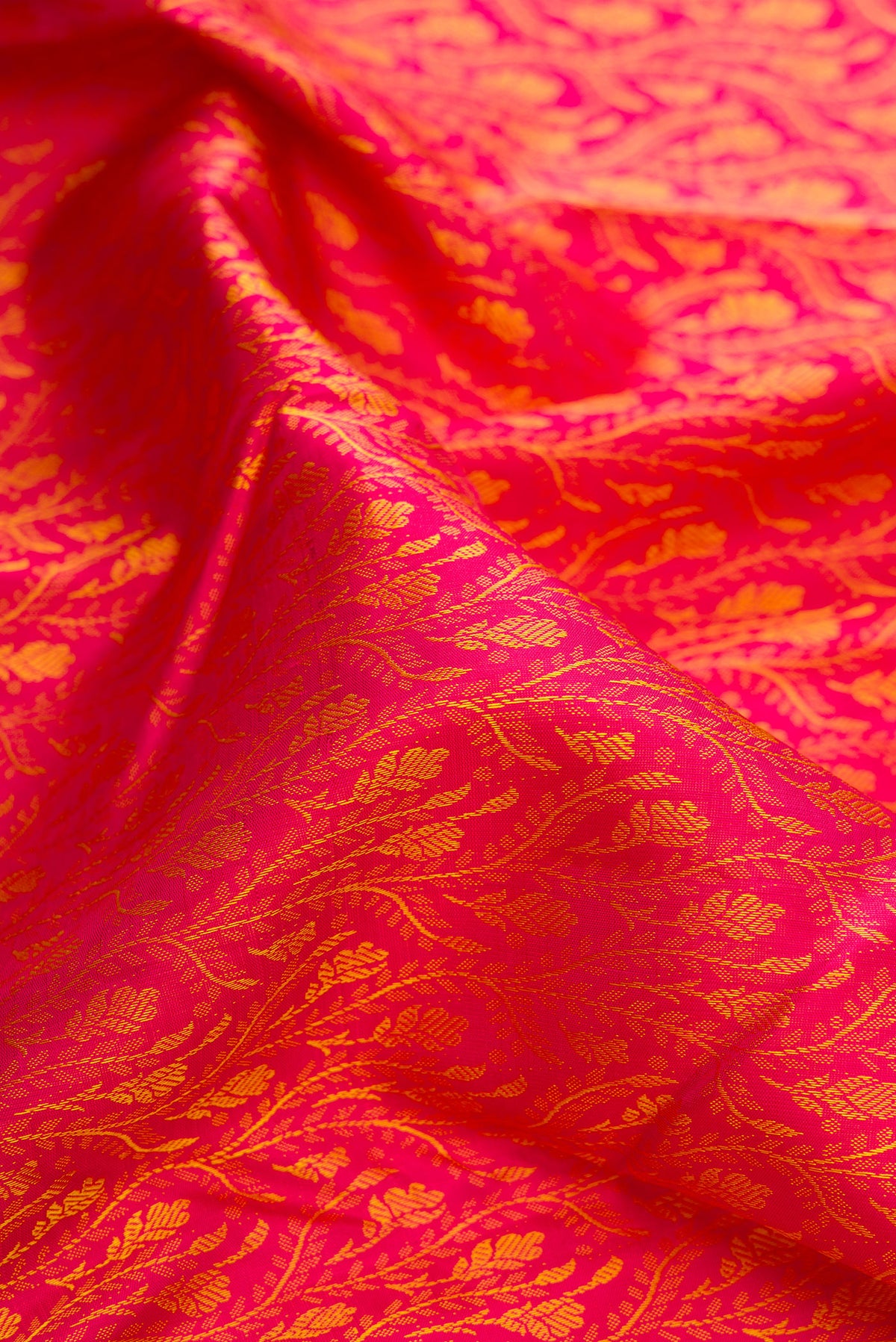 Close up of Pure Silk Pink Dual Tone Kanchipuram Saree with Jacquard design on the body and Zari Border.  displaying folds