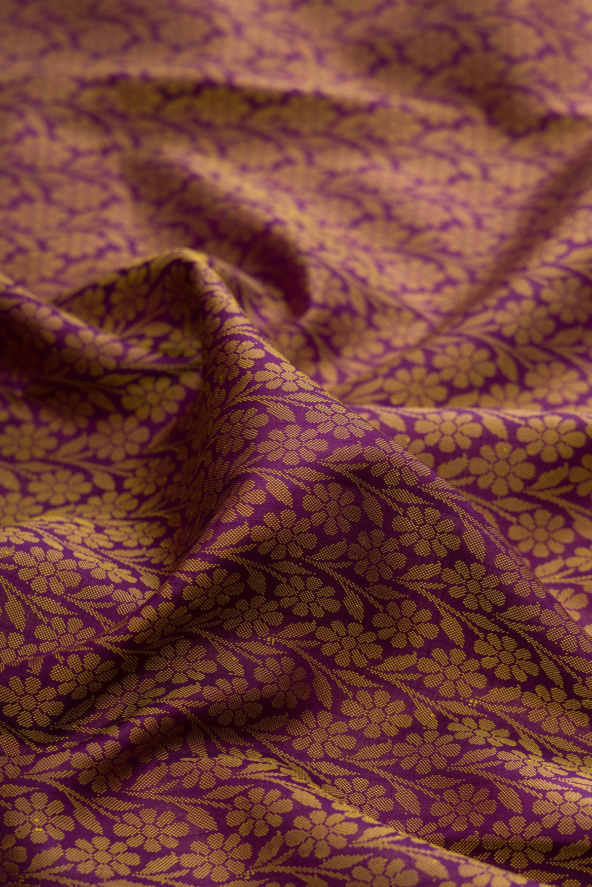 Close up of Pure Silk Purple Kanchipuram Saree with Jacquard design on the body and Zari Border.  displaying folds