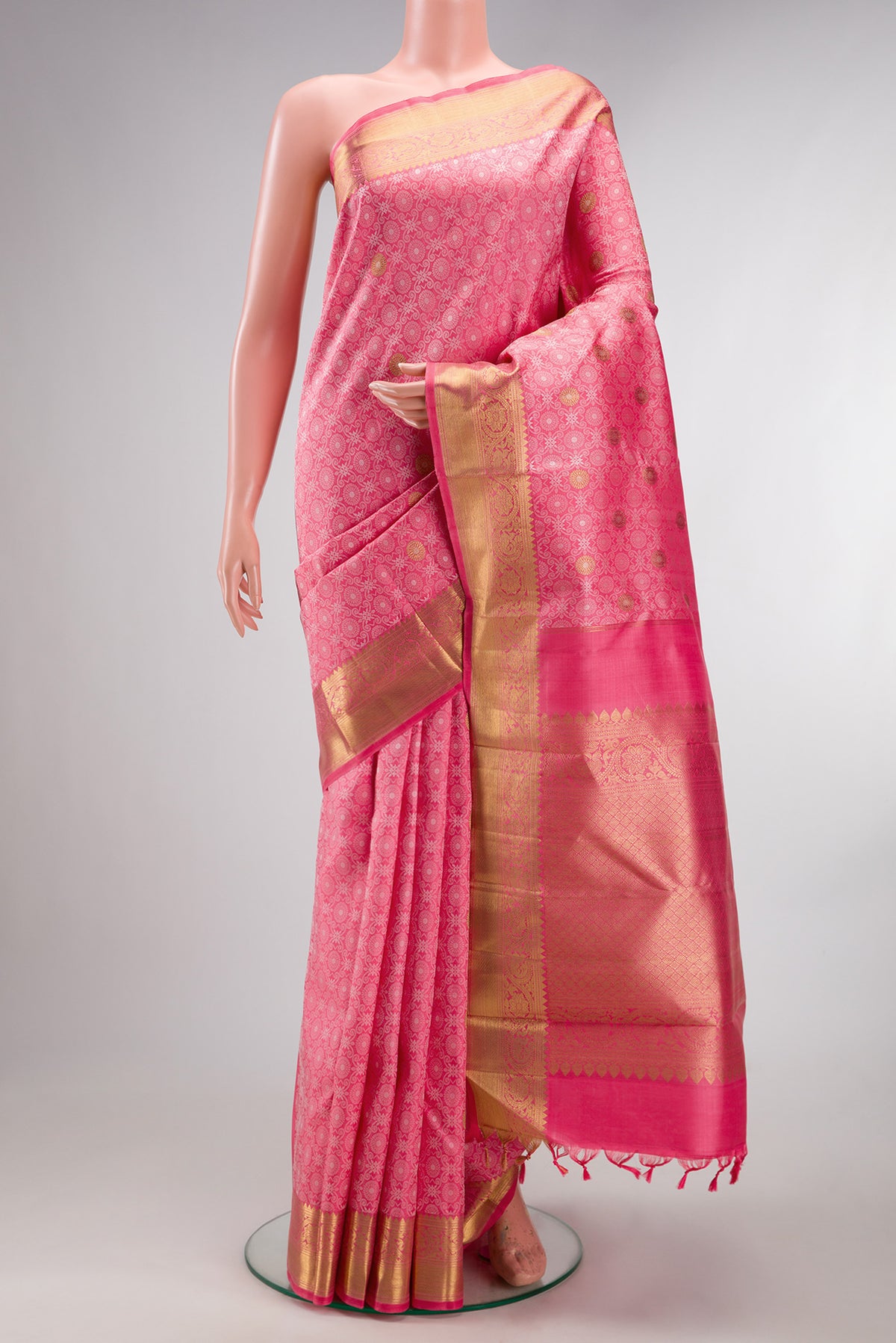 Pure Silk Pink Kanchipuram Saree with Jacquard design on the body and Zari Border.  displayed on a mannequin