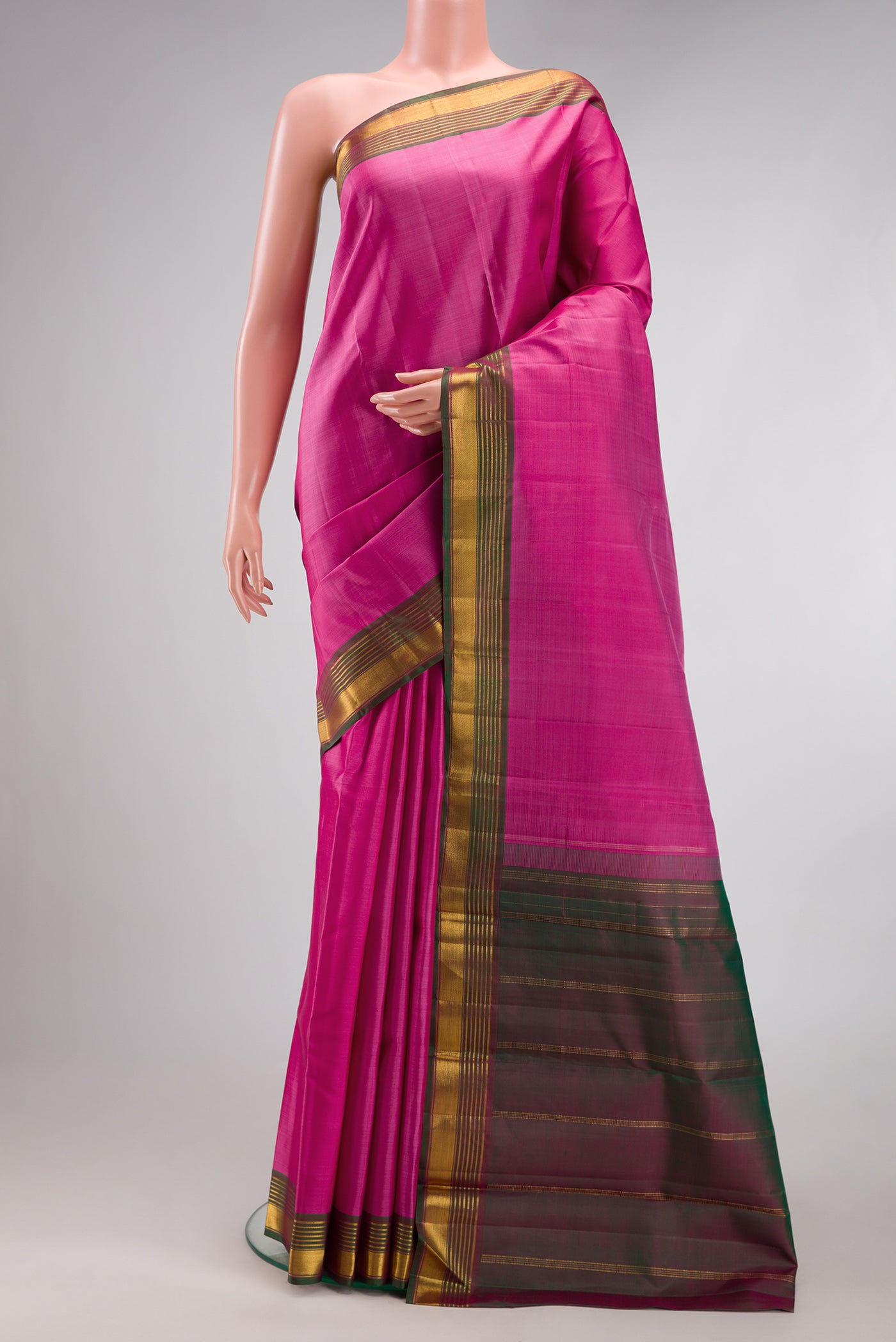 Pink Kanjivaram Silk Saree with Plain Body and Zari Border.  displayed on a mannequin