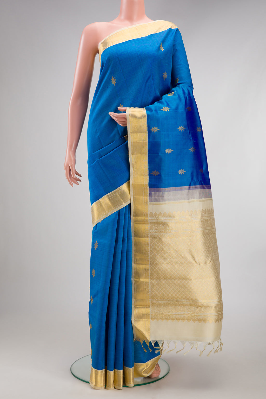 Royal Blue Kanjivaram Silk Saree with Zari Butta on the body and Zari Border.  displayed on a mannequin