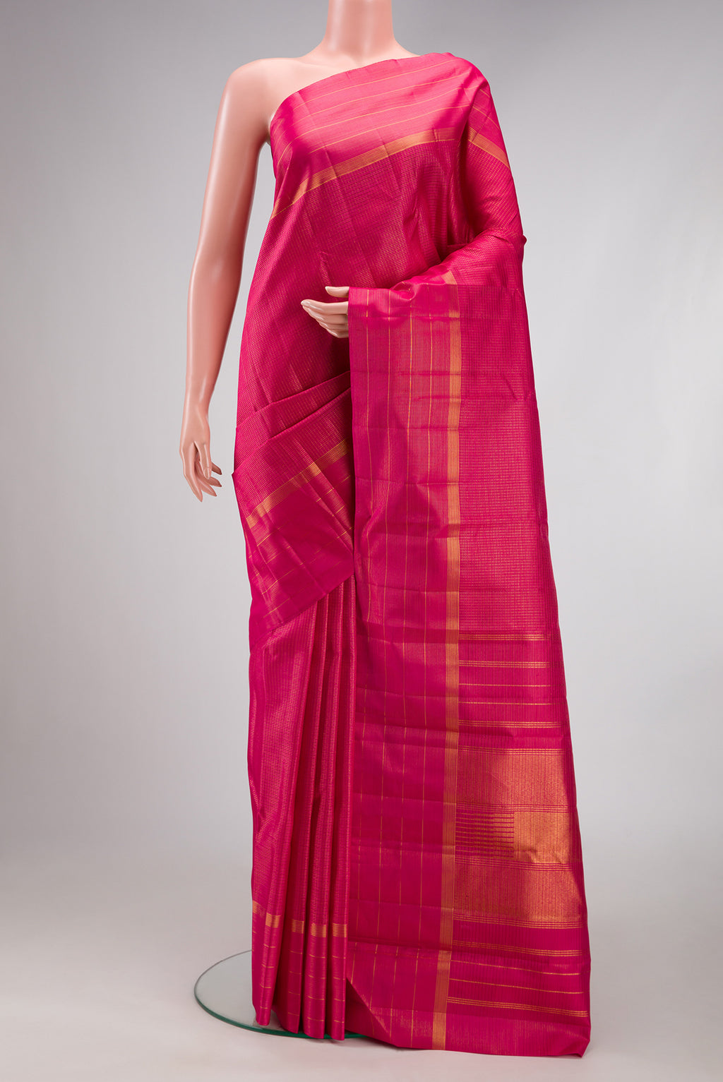 Dark Pink Kanchipuram Silk Saree with Checked design on the body and Zari Border.  displayed on a mannequin