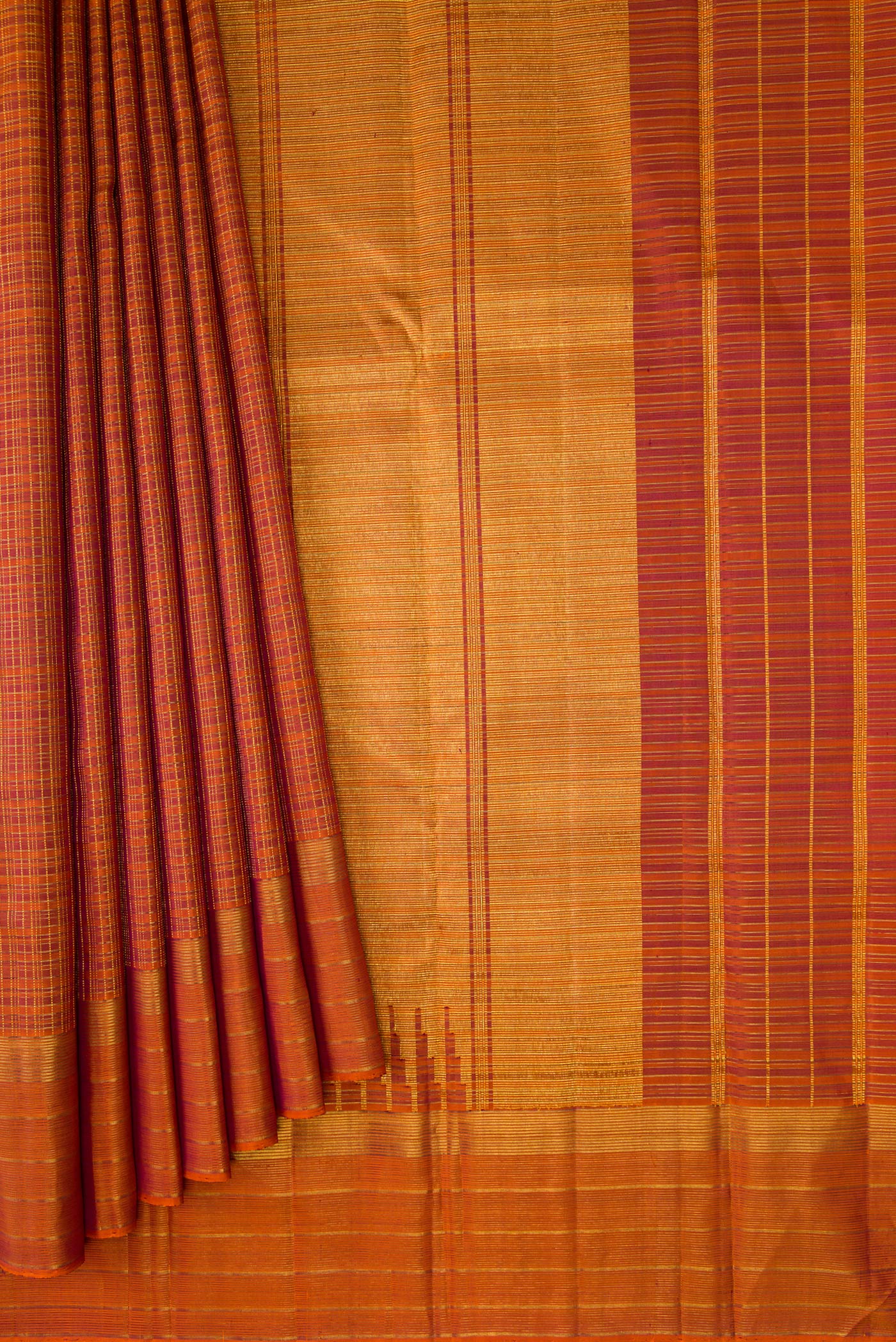 Pleats and pallu of Brick Orange Kanchipuram Silk Saree with Checked design on the body and Zari Border. 