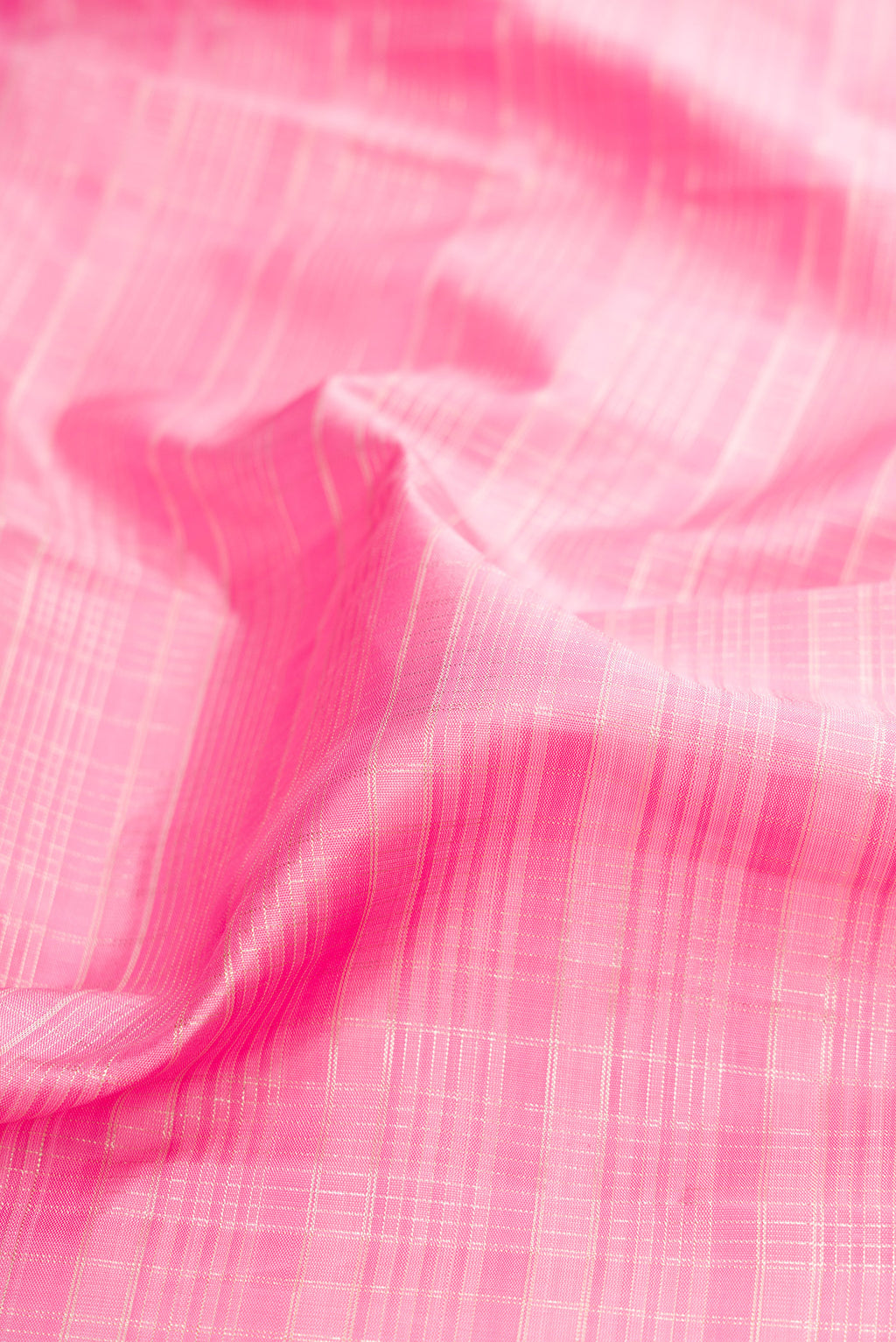 Close up of Rose pink Kanjivaram Silk Saree with Checked design on the body and Zari Border.  displaying folds