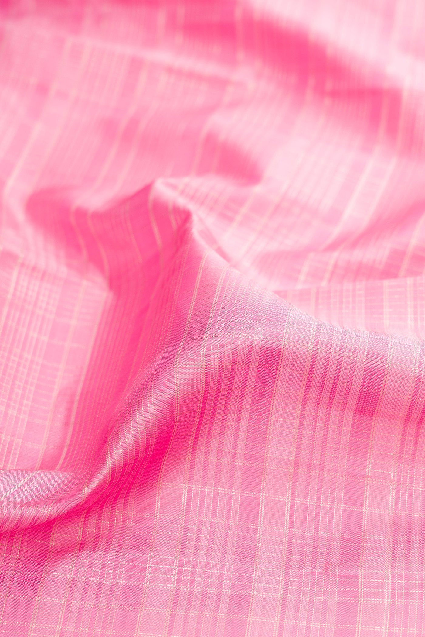 Close up of Rose pink Kanjivaram Silk Saree with Checked design on the body and Zari Border.  displaying folds