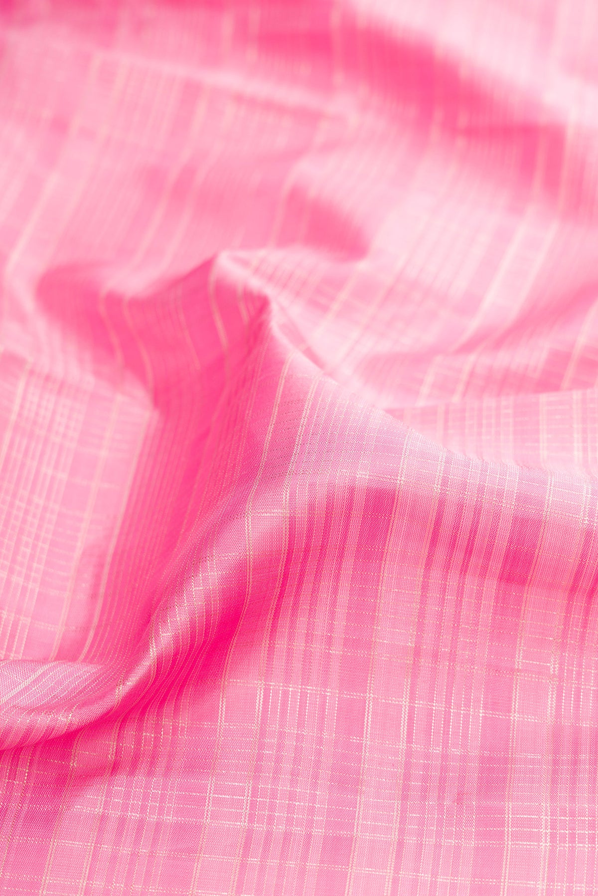 Close up of Rose pink Kanjivaram Silk Saree with Checked design on the body and Zari Border.  displaying folds