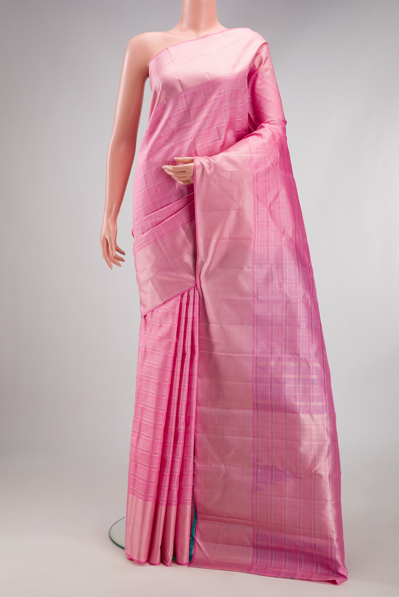 Rose pink Kanjivaram Silk Saree with Checked design on the body and Zari Border.  displayed on a mannequin