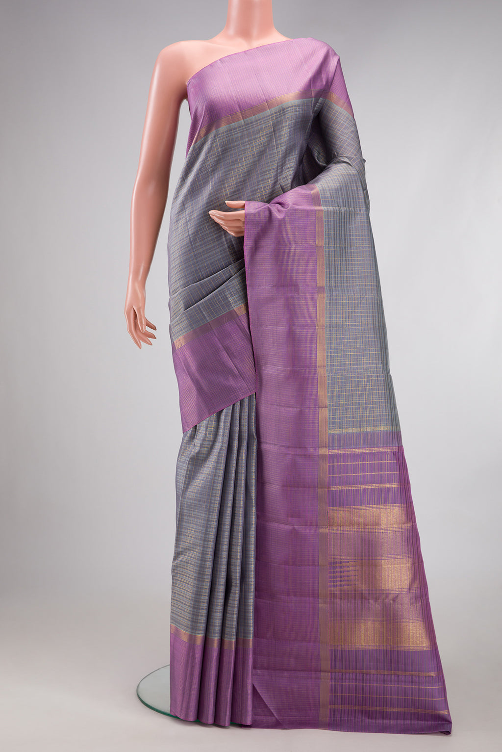 Grey Kanjivaram Silk Saree with Checked design on the body and Zari Border.  displayed on a mannequin