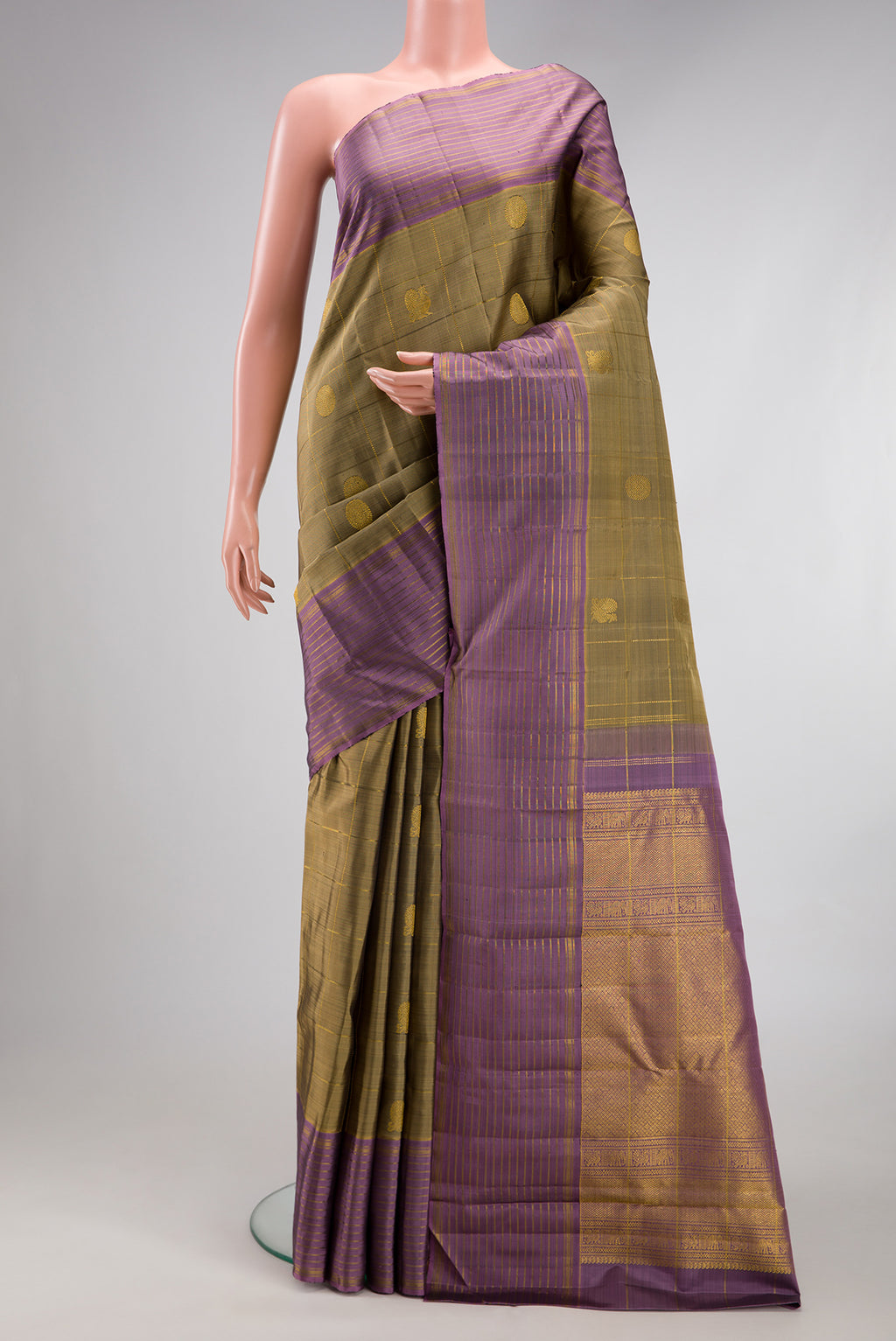 Mehandi Green Kanjivaram Silk Saree with Checked design on the body and Zari Border.  displayed on a mannequin