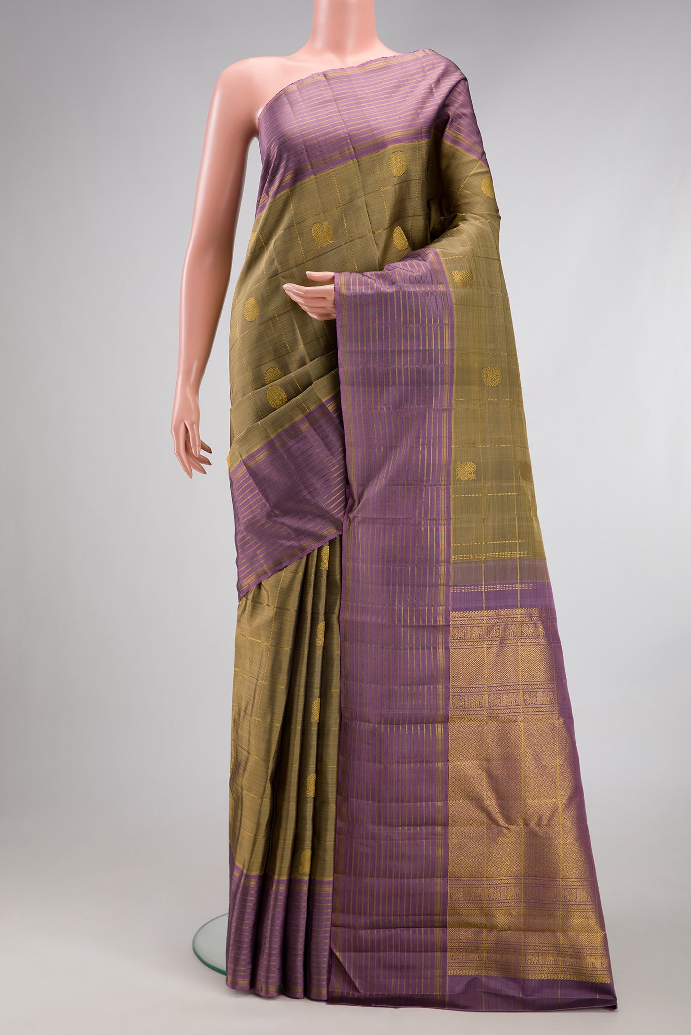 Mehandi Green Kanjivaram Silk Saree with Checked design on the body and Zari Border.  displayed on a mannequin