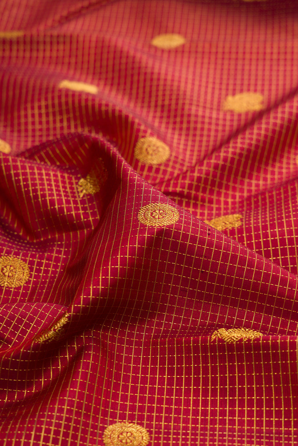 Close up of Rust Dual Tone Kanjivaram Silk Saree with Checked design on the body and Fancy Border.  displaying folds