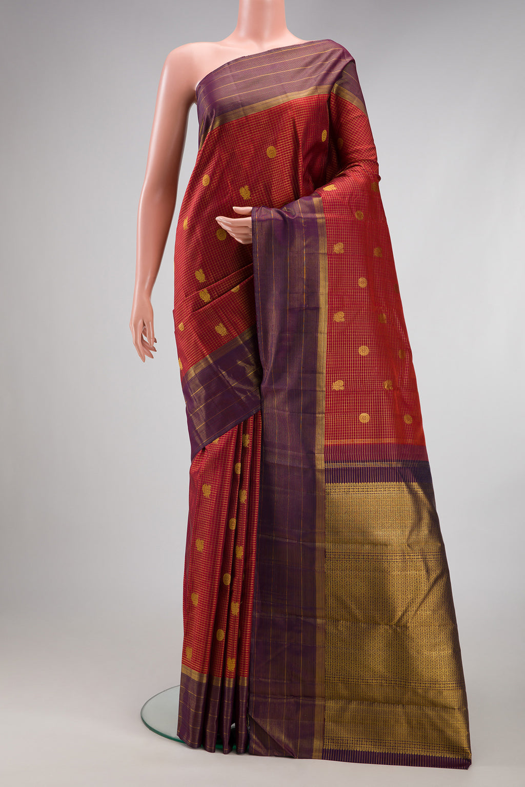 Rust Dual Tone Kanjivaram Silk Saree with Checked design on the body and Fancy Border.  displayed on a mannequin