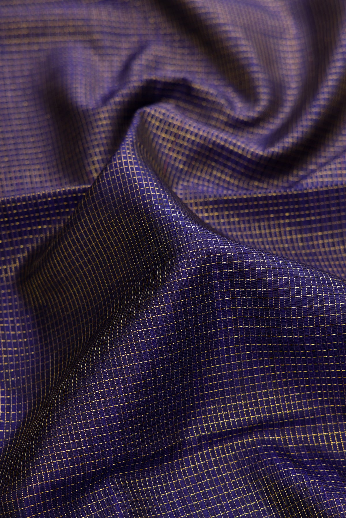 Close up of Pure Silk Navy Blue Kanjivaram Saree with Checked design on the body and Fancy Border.  displaying folds