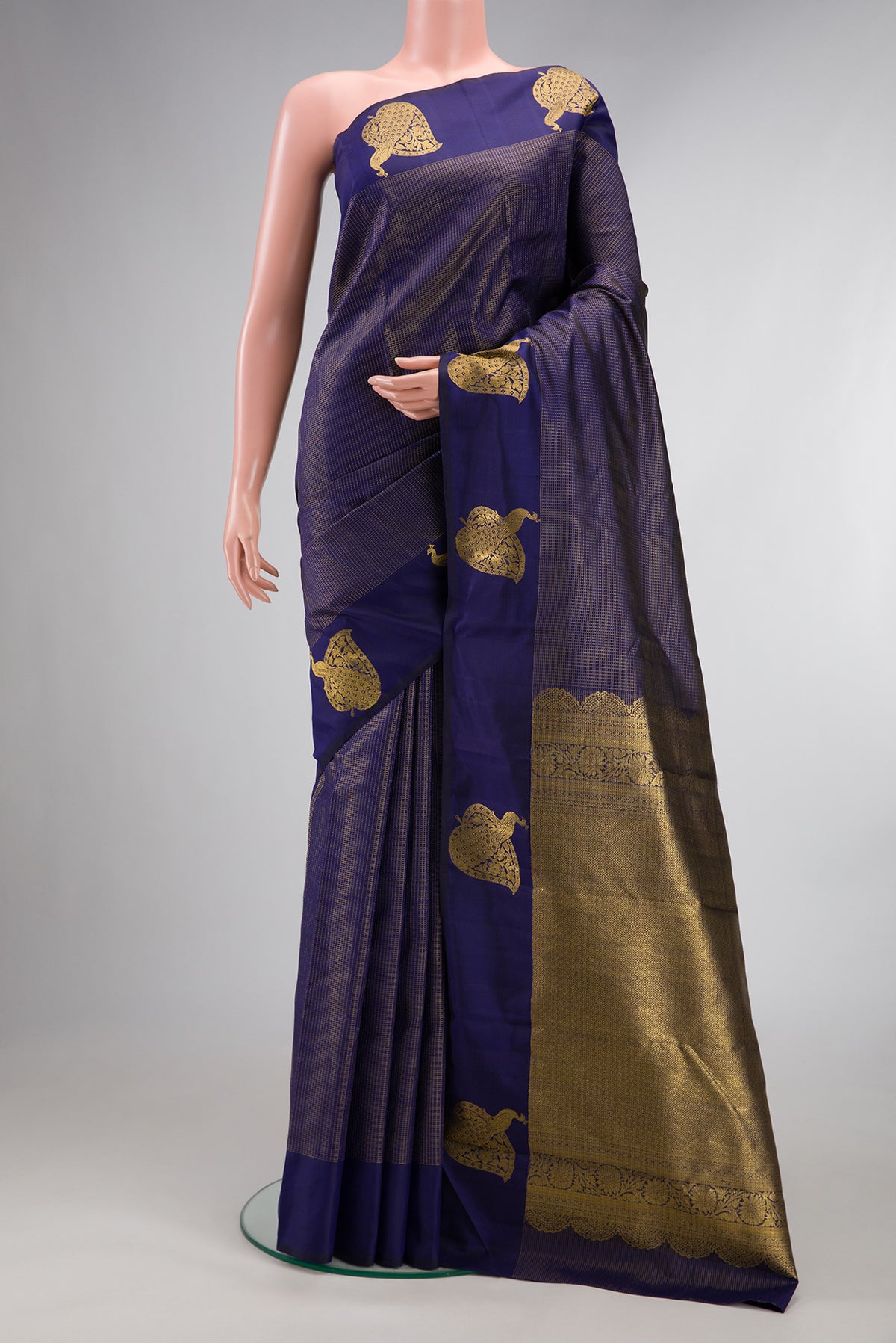Pure Silk Navy Blue Kanjivaram Saree with Checked design on the body and Fancy Border.  displayed on a mannequin