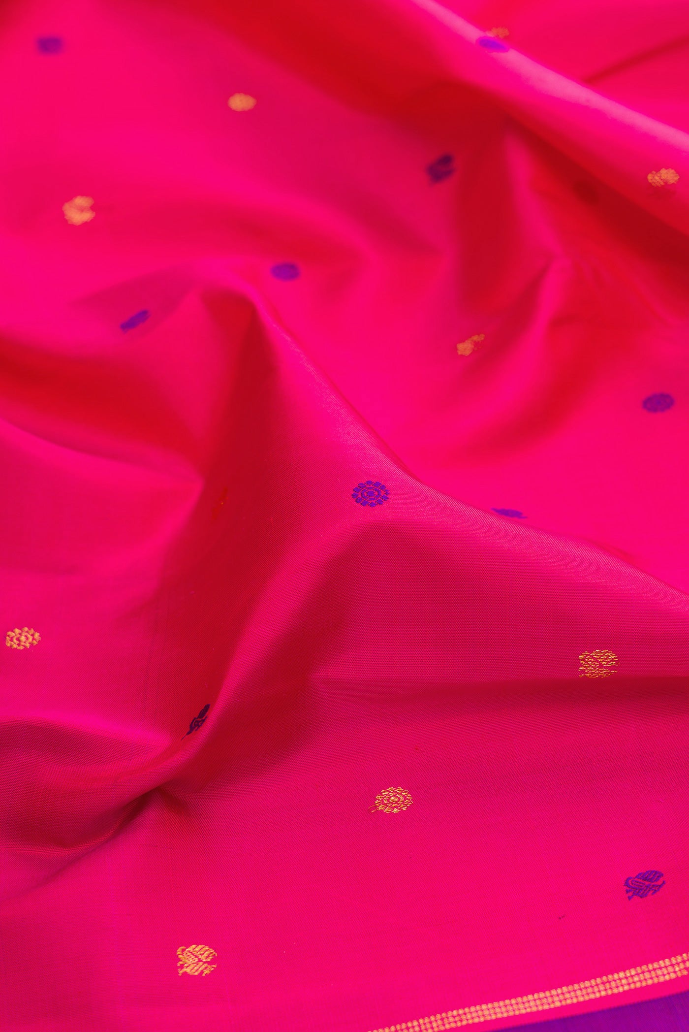 Close up of Pink Kanjivaram Silk Saree with Zari And Thread Butta on the body and Without Border.  displaying folds
