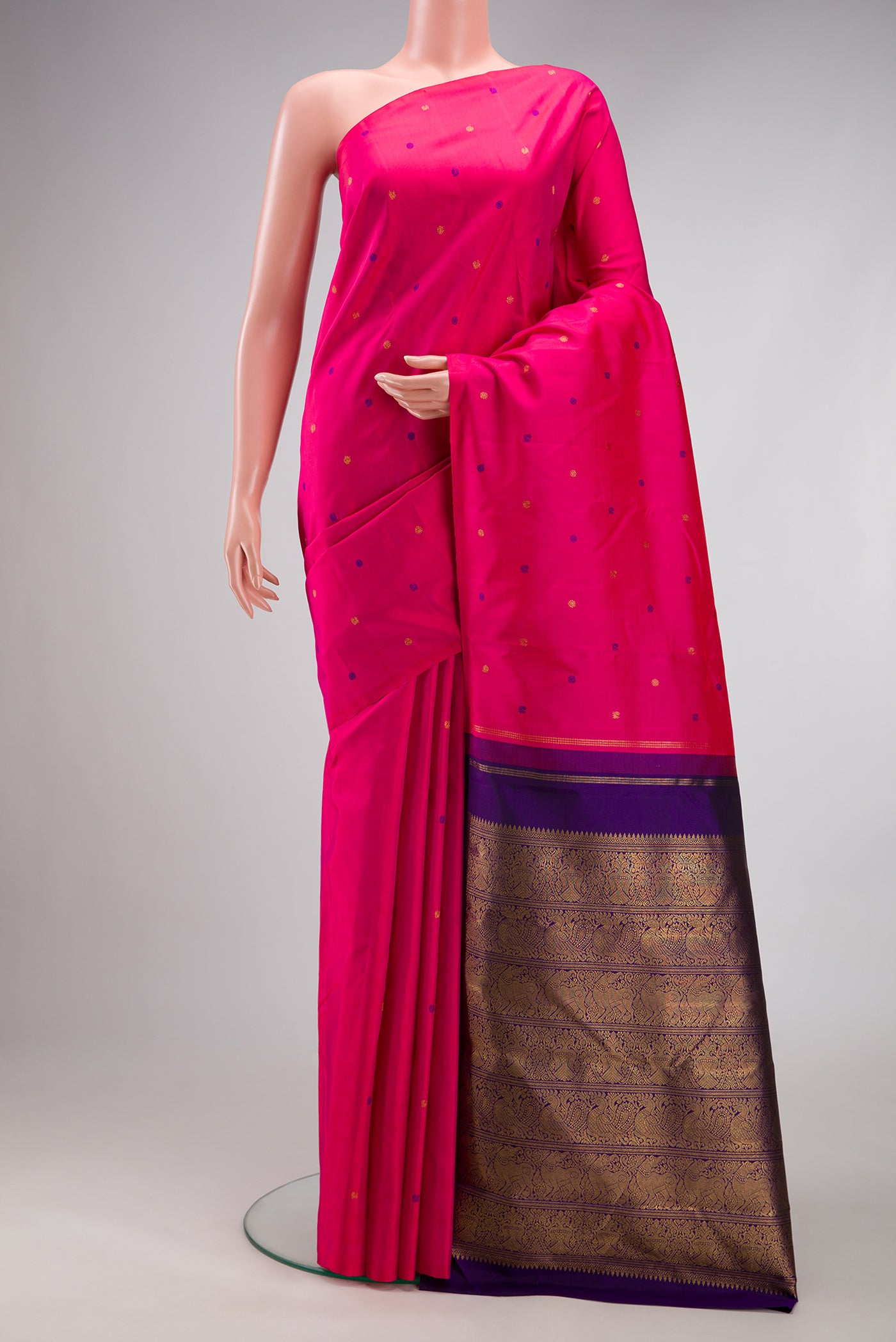 Pink Kanjivaram Silk Saree with Zari And Thread Butta on the body and Without Border.  displayed on a mannequin