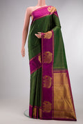 Bottle Green Kanjivaram Silk Saree with Checked design on the body and Zari Border.  displayed on a mannequin