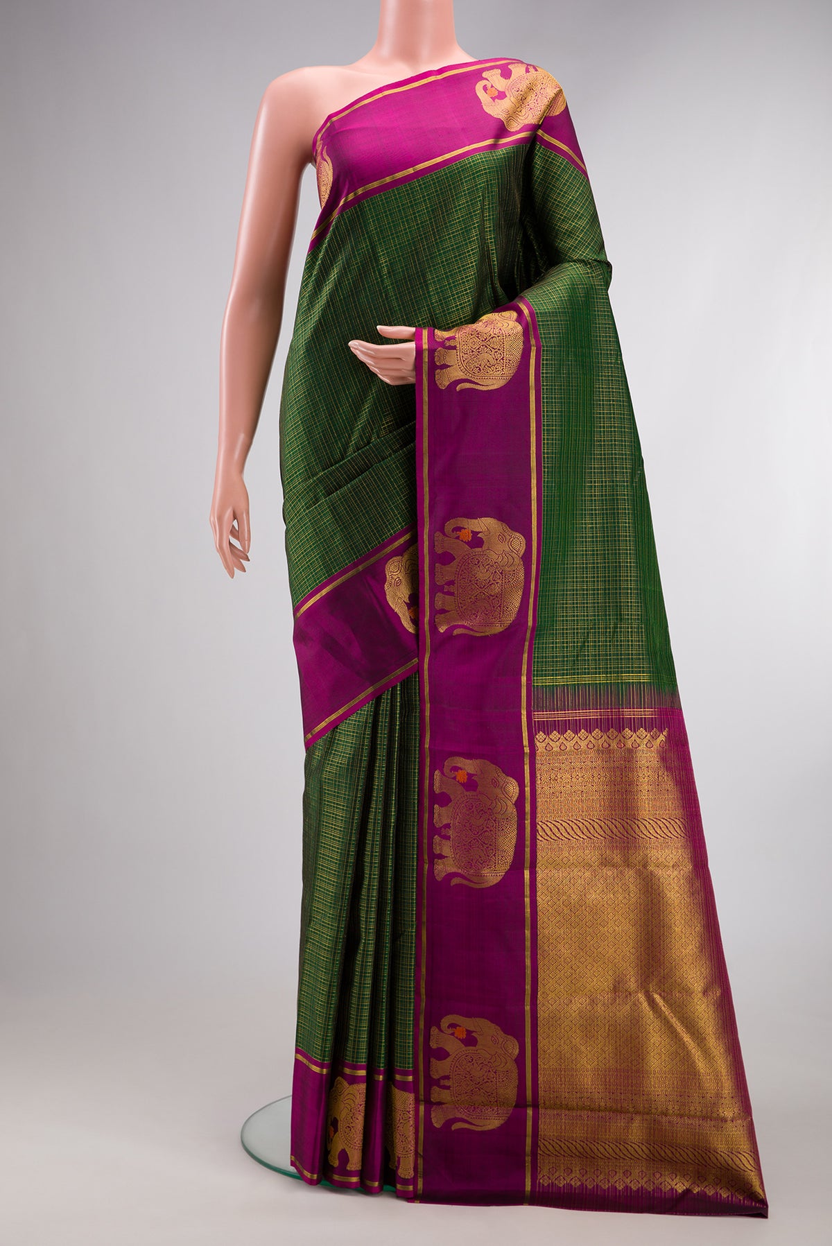 Bottle Green Kanjivaram Silk Saree with Checked design on the body and Zari Border.  displayed on a mannequin