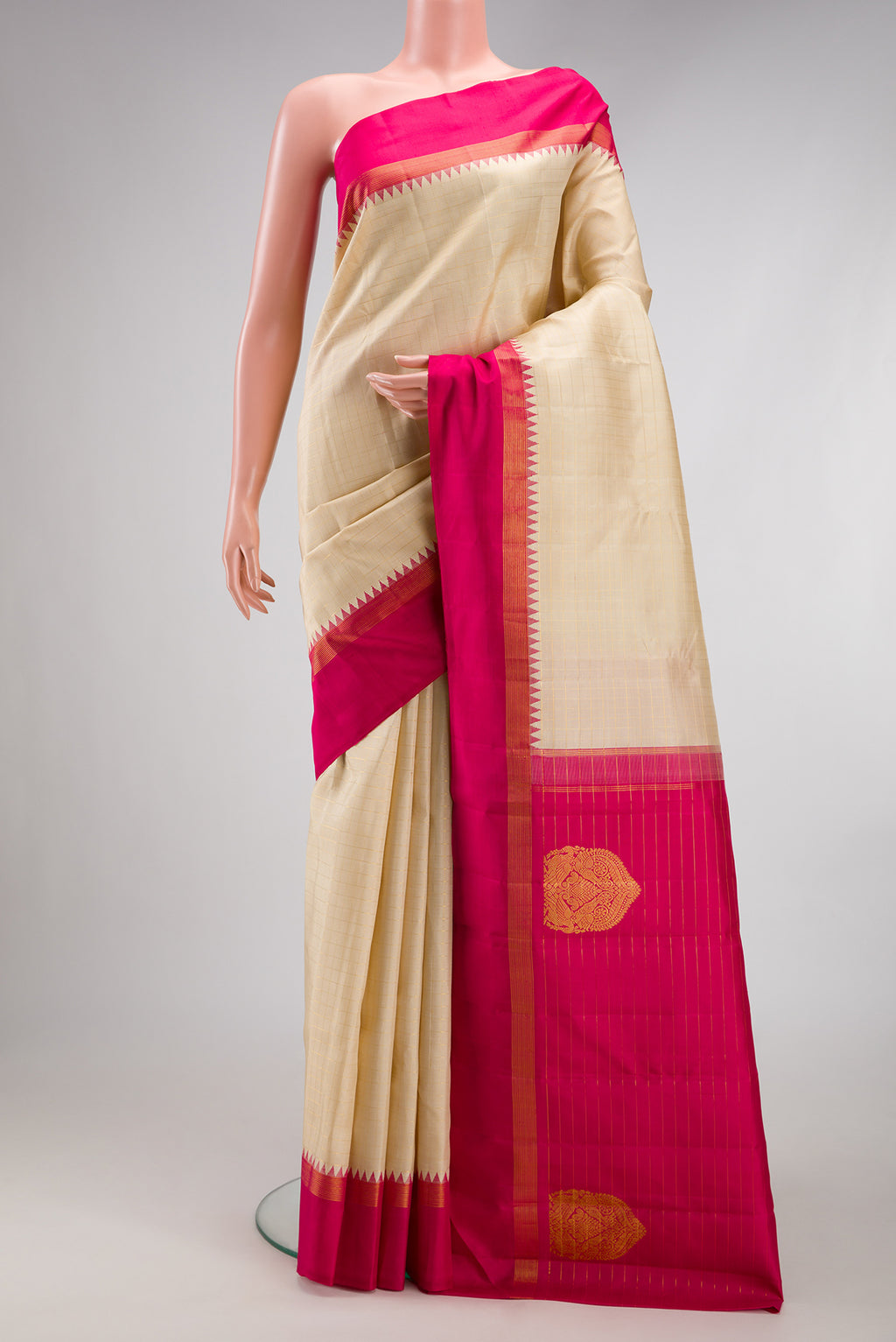 Beige Kanjivaram Silk Saree with Checked design on the body and Temple Border.  displayed on a mannequin