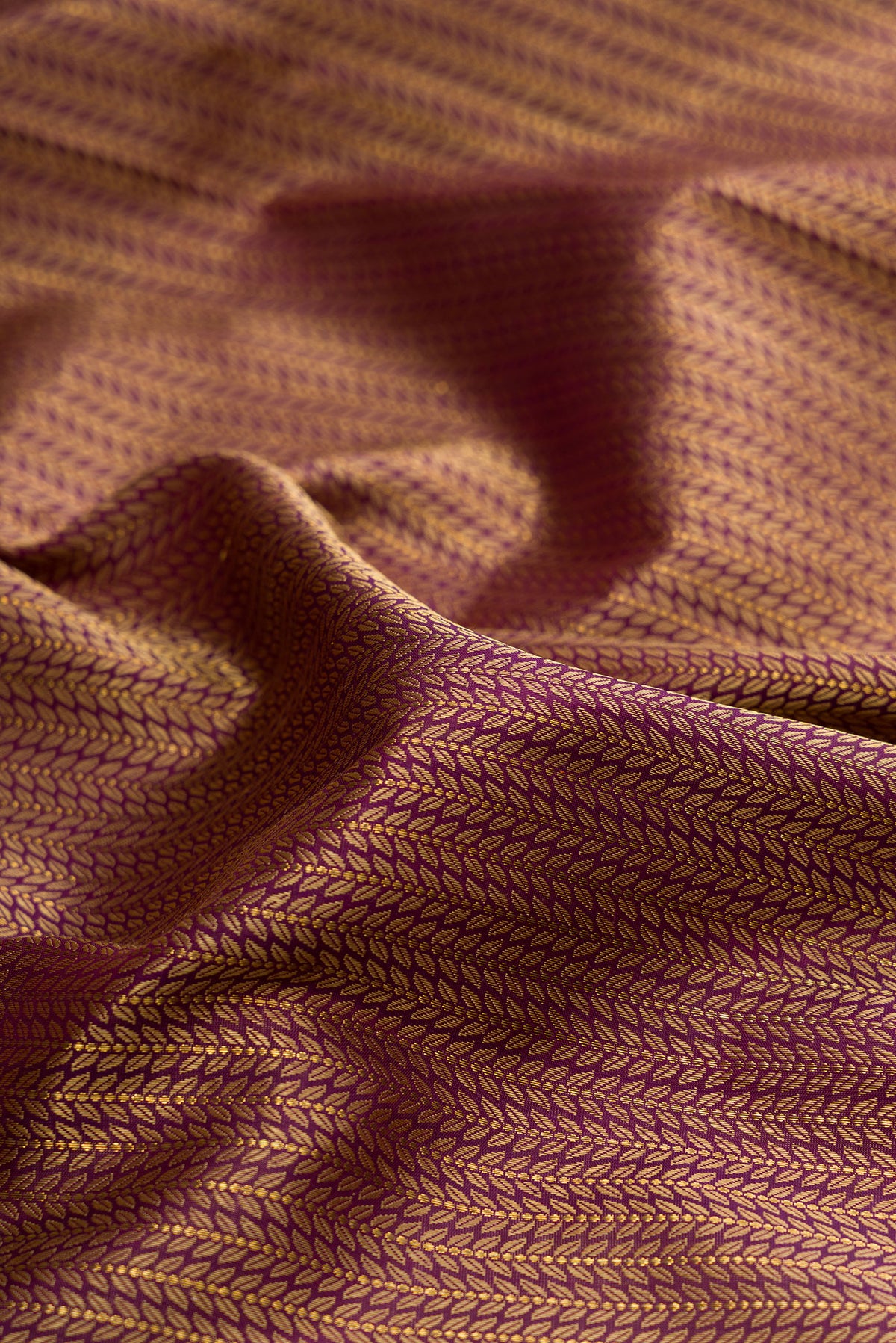 Close up of Pure Silk Purple Kanchipuram Saree with Jacquard design on the body and Zari Border.  displaying folds