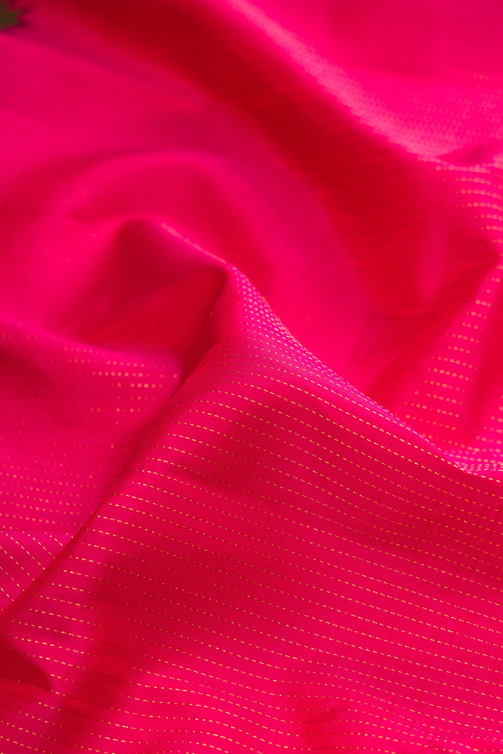 Close up of Pink Kanchipuram Silk Saree with Stripes on the body and Zari Border.  displaying folds