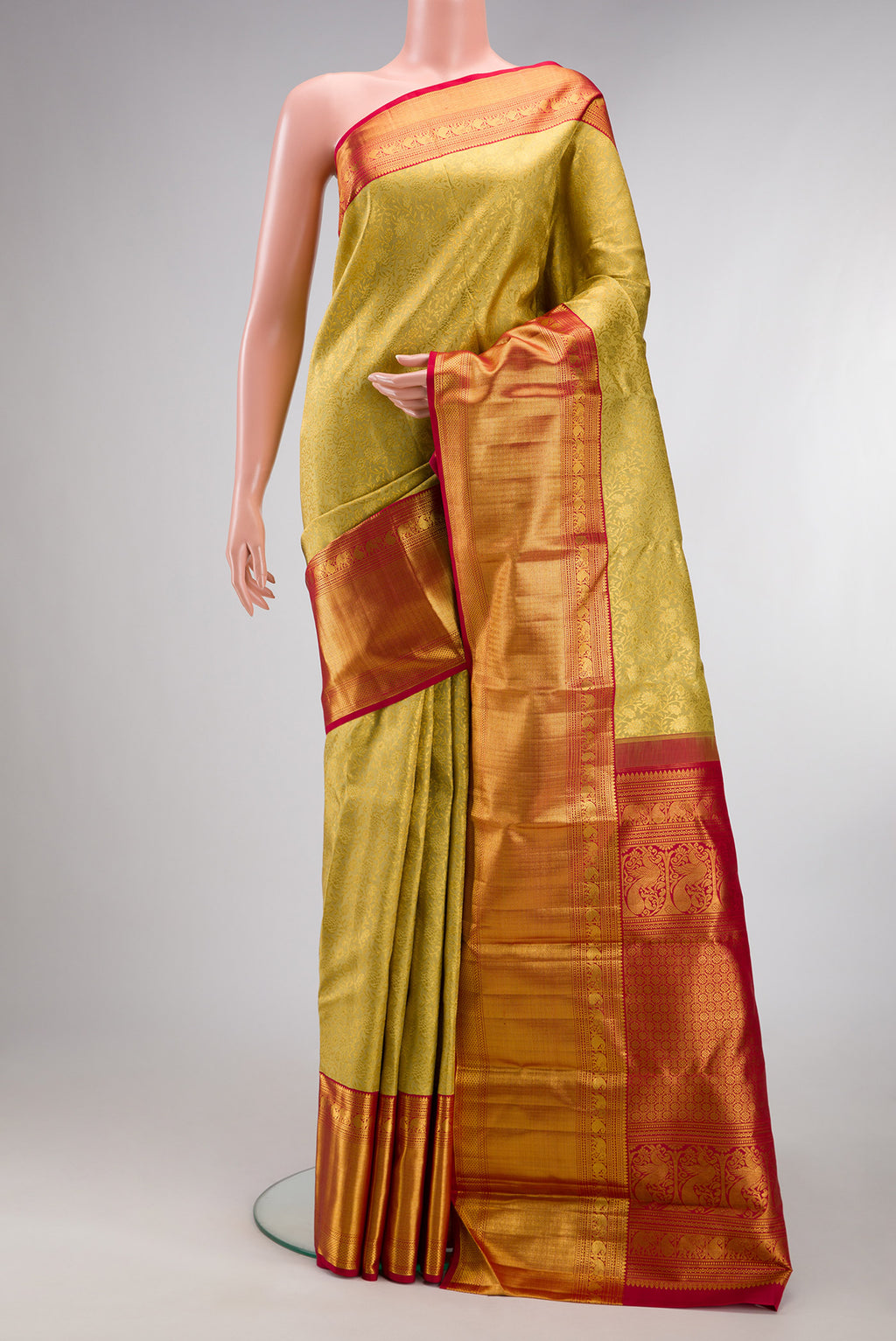 Pure Silk Gold Kanchipuram Saree with Zari Brocade on the body and Zari Border.  displayed on a mannequin