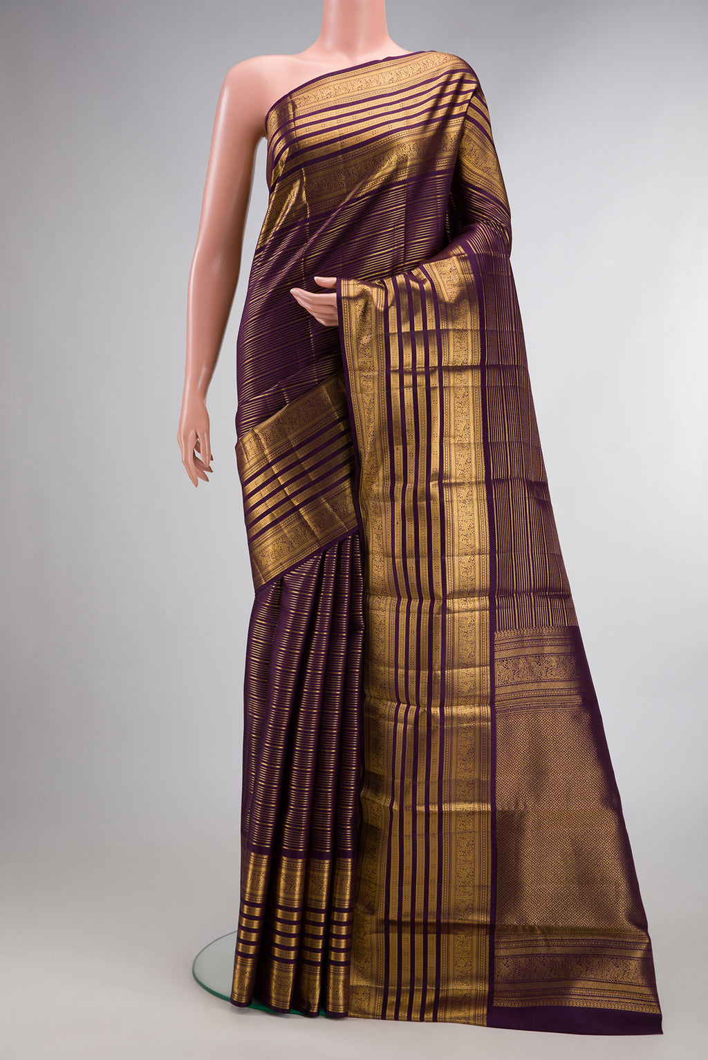 Pure Silk Burgundy Dual Tone Kanjivaram Saree with Stripes on the body and Zari Border.  displayed on a mannequin