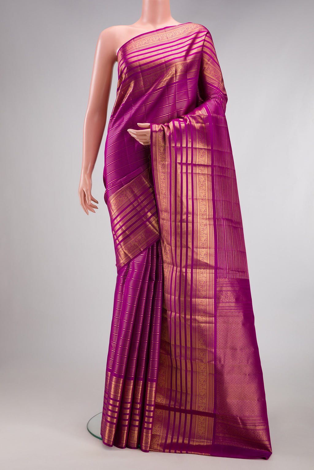 Magenta Kanjivaram Silk Saree with Stripes on the body and Fancy Border.  displayed on a mannequin