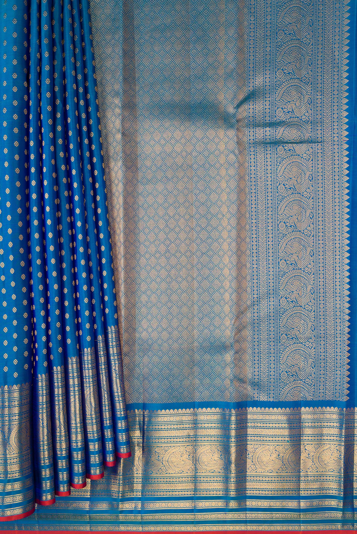 Pleats and pallu of Peacock Blue Kanjivaram Silk Saree with Zari Butta on the body and Zari Border. 