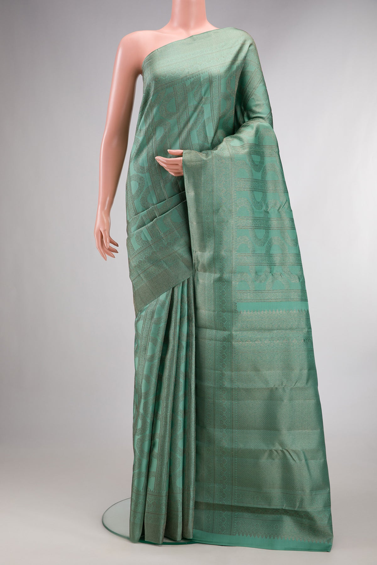 Pure Silk Sea Green Kanjivaram Saree with Zari Brocade on the body and Fancy Border.  displayed on a mannequin