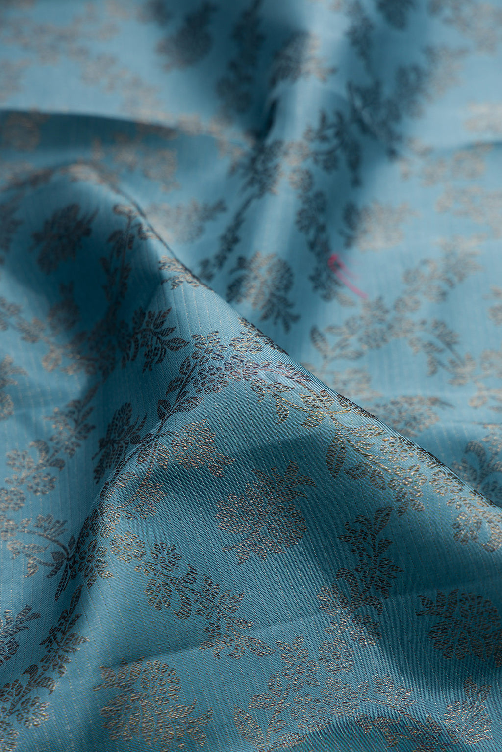 Close up of Pure Silk Maya Blue Dual Tone Kanjivaram Saree with Zari Brocade on the body and Fancy Border.  displaying folds