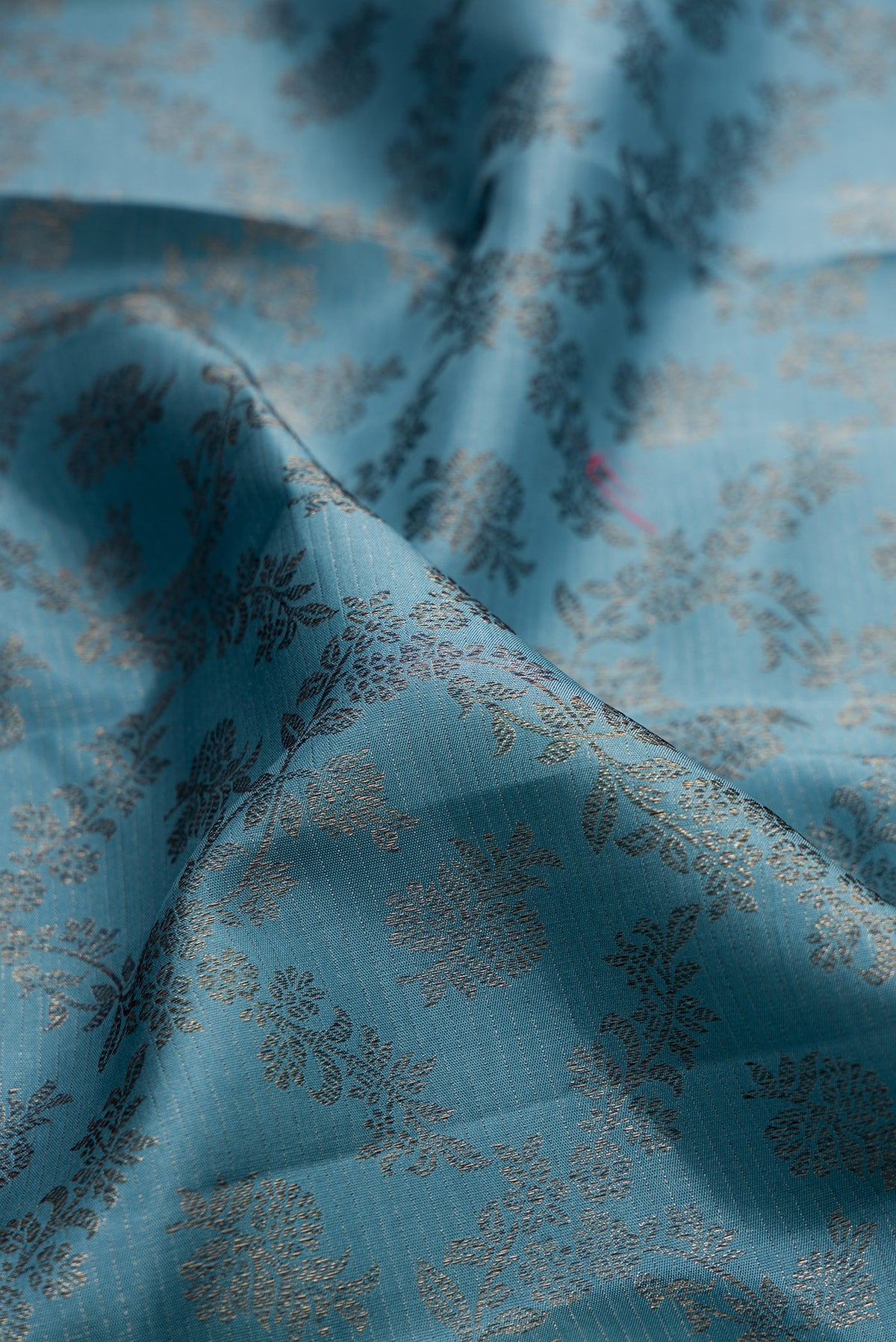Close up of Pure Silk Maya Blue Dual Tone Kanjivaram Saree with Zari Brocade on the body and Fancy Border.  displaying folds