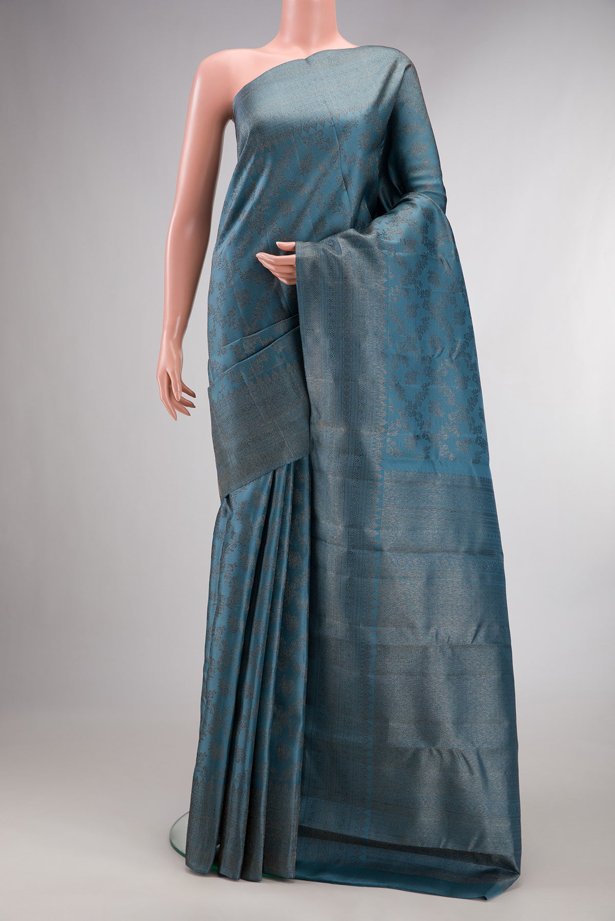 Pure Silk Maya Blue Dual Tone Kanjivaram Saree with Zari Brocade on the body and Fancy Border.  displayed on a mannequin
