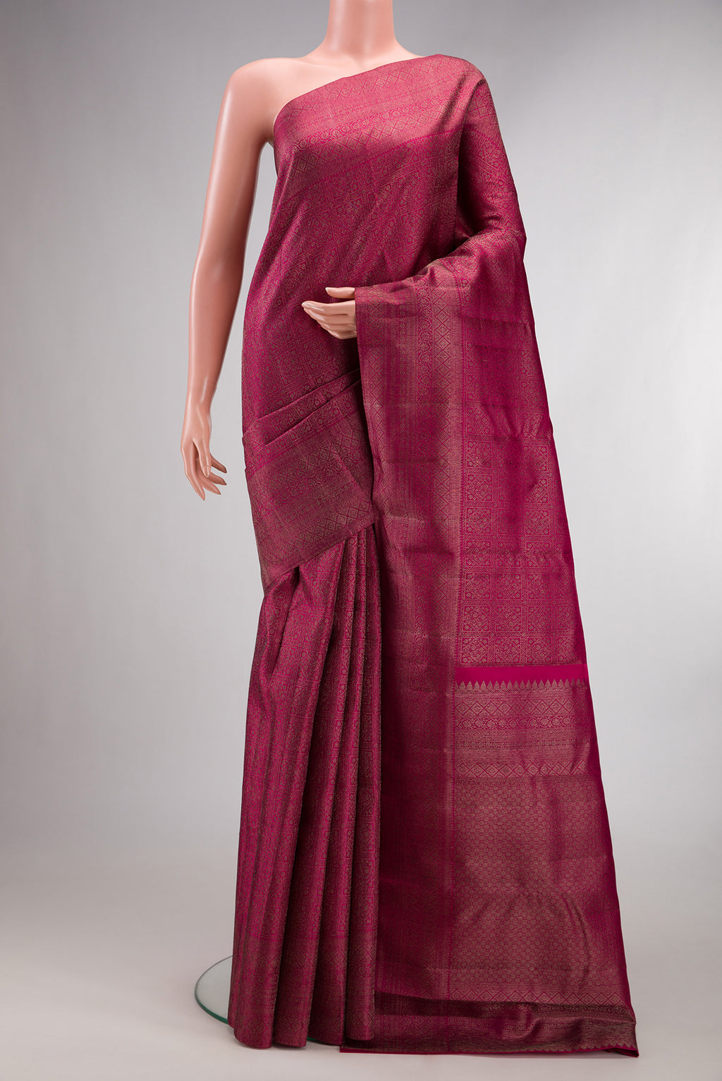 Pure Silk Dark Pink Kanjivaram Saree with Zari Brocade on the body and Fancy Border.  displayed on a mannequin