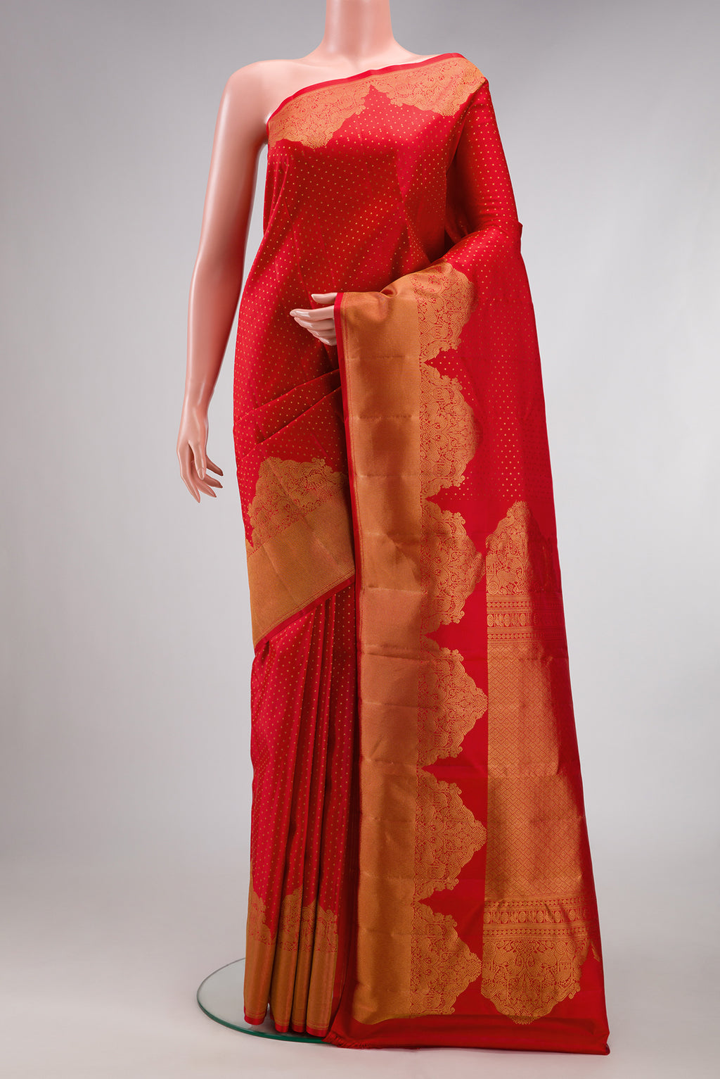 Red Kanjivaram Silk Saree with Zari Butta on the body and Fancy Border.  displayed on a mannequin