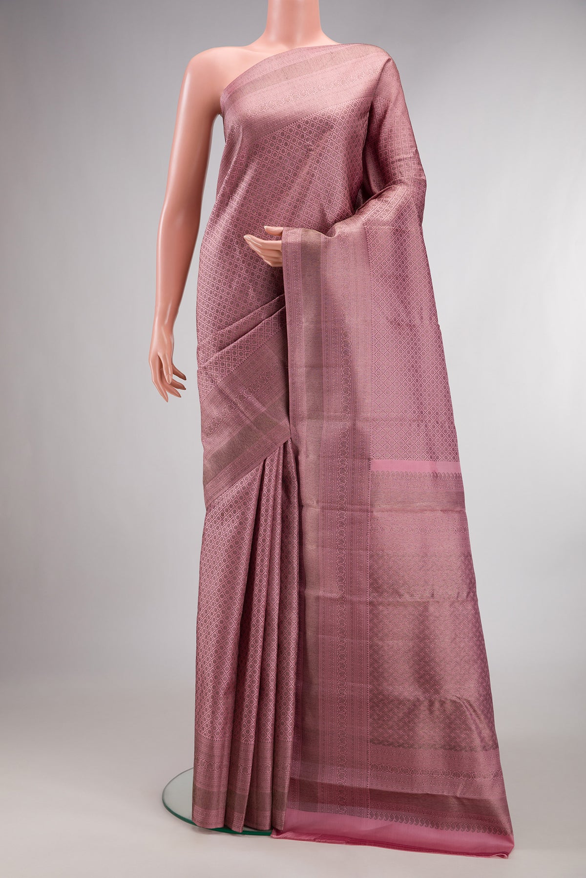Pure Silk Rose Gold Dual Tone Kanjivaram Saree with Zari Brocade on the body and Fancy Border.  displayed on a mannequin