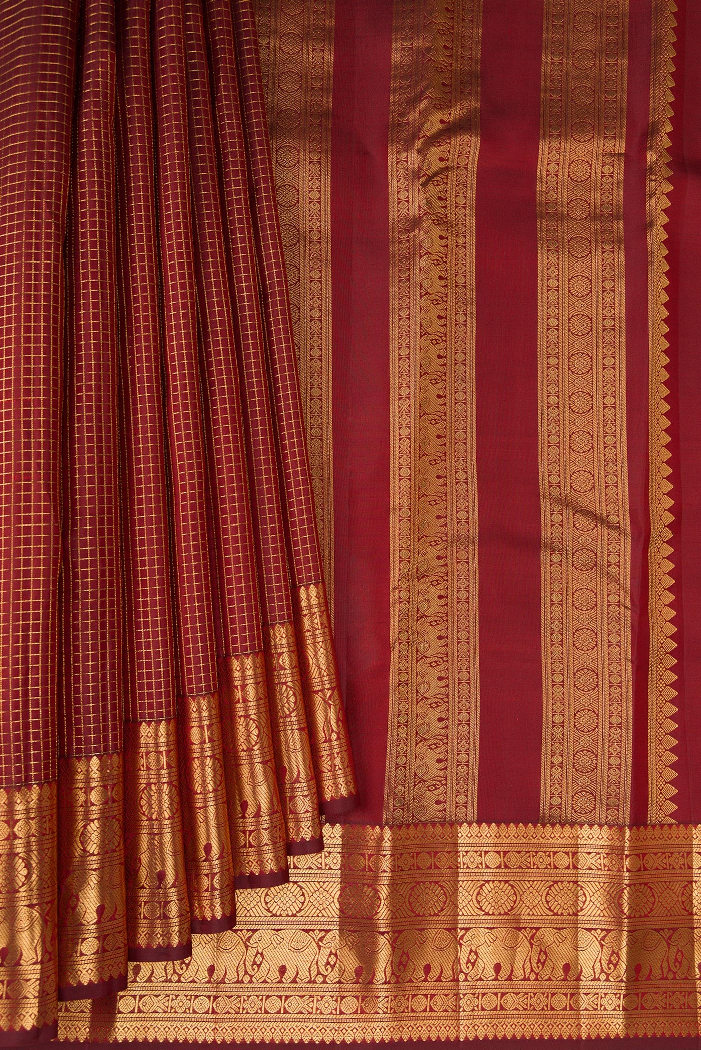 Pleats and pallu of Maroon Kanjivaram Silk Saree with Checked design on the body and Zari Border. 