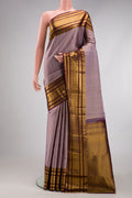 Lilac Kanjivaram Silk Saree with Checked design on the body and Zari Border.  displayed on a mannequin