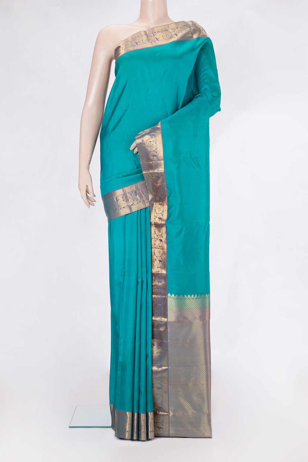 Peacock Blue Kanjivaram Silk Saree with Plain Body and Zari Border.  displayed on a mannequin