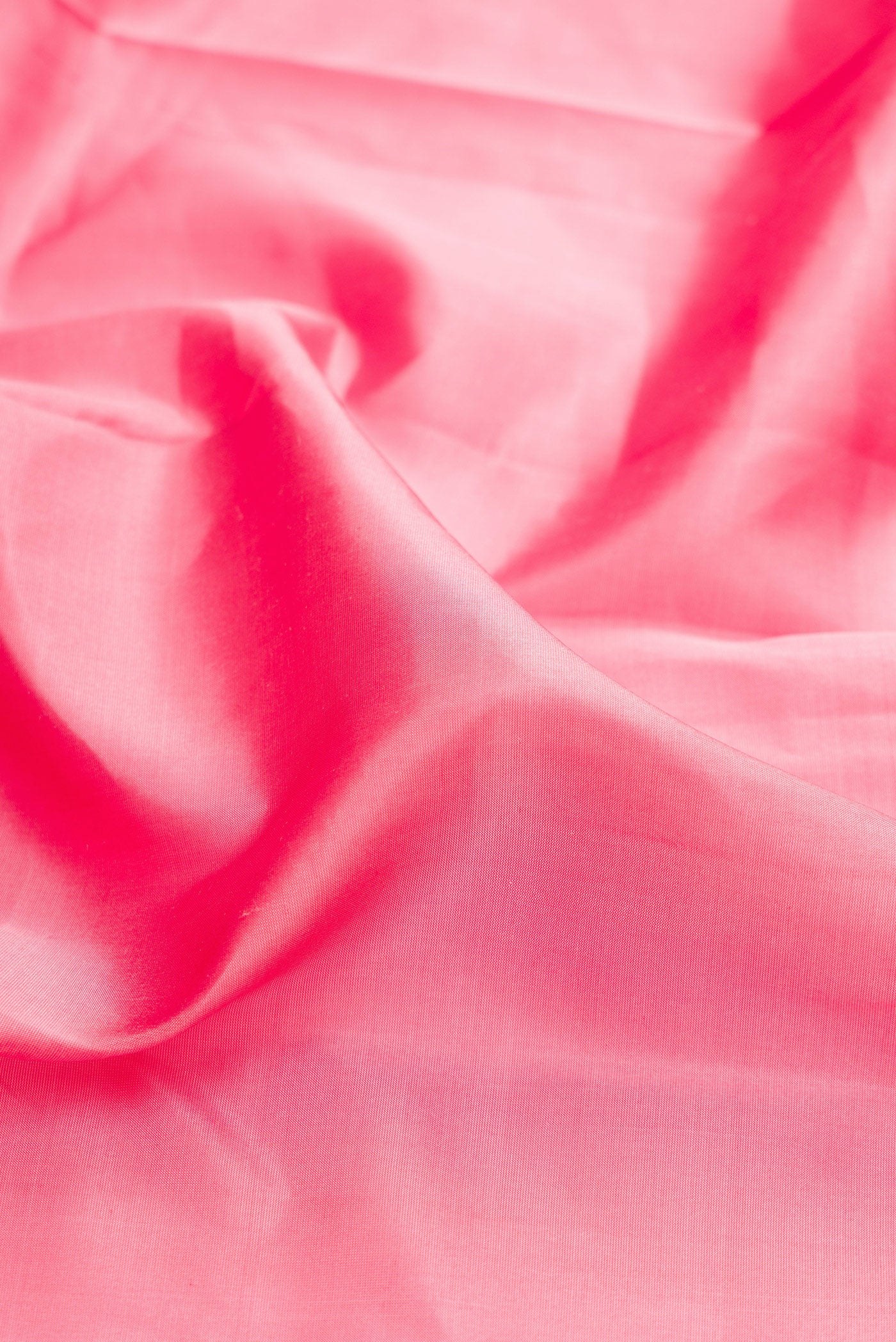 Close up of Rose pink Kanjivaram Silk Saree with Plain Body and Zari Border.  displaying folds