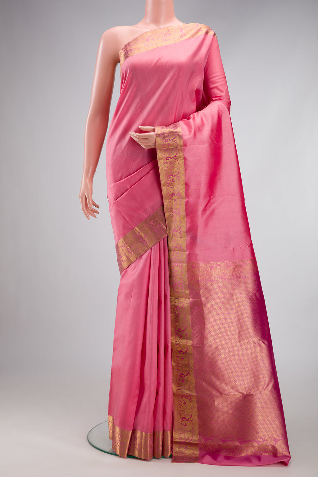 Rose pink Kanjivaram Silk Saree with Plain Body and Zari Border.  displayed on a mannequin