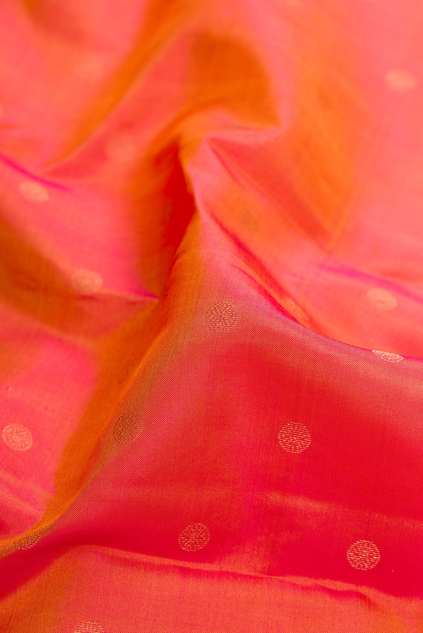 Close up of Gold Dual Tone Kanchipuram Silk Saree with Zari Butta on the body and Fancy Border.  displaying folds