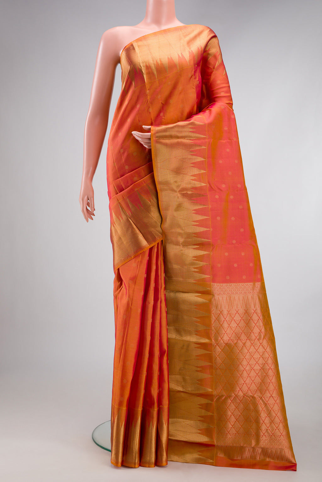 Gold Dual Tone Kanchipuram Silk Saree with Zari Butta on the body and Fancy Border.  displayed on a mannequin